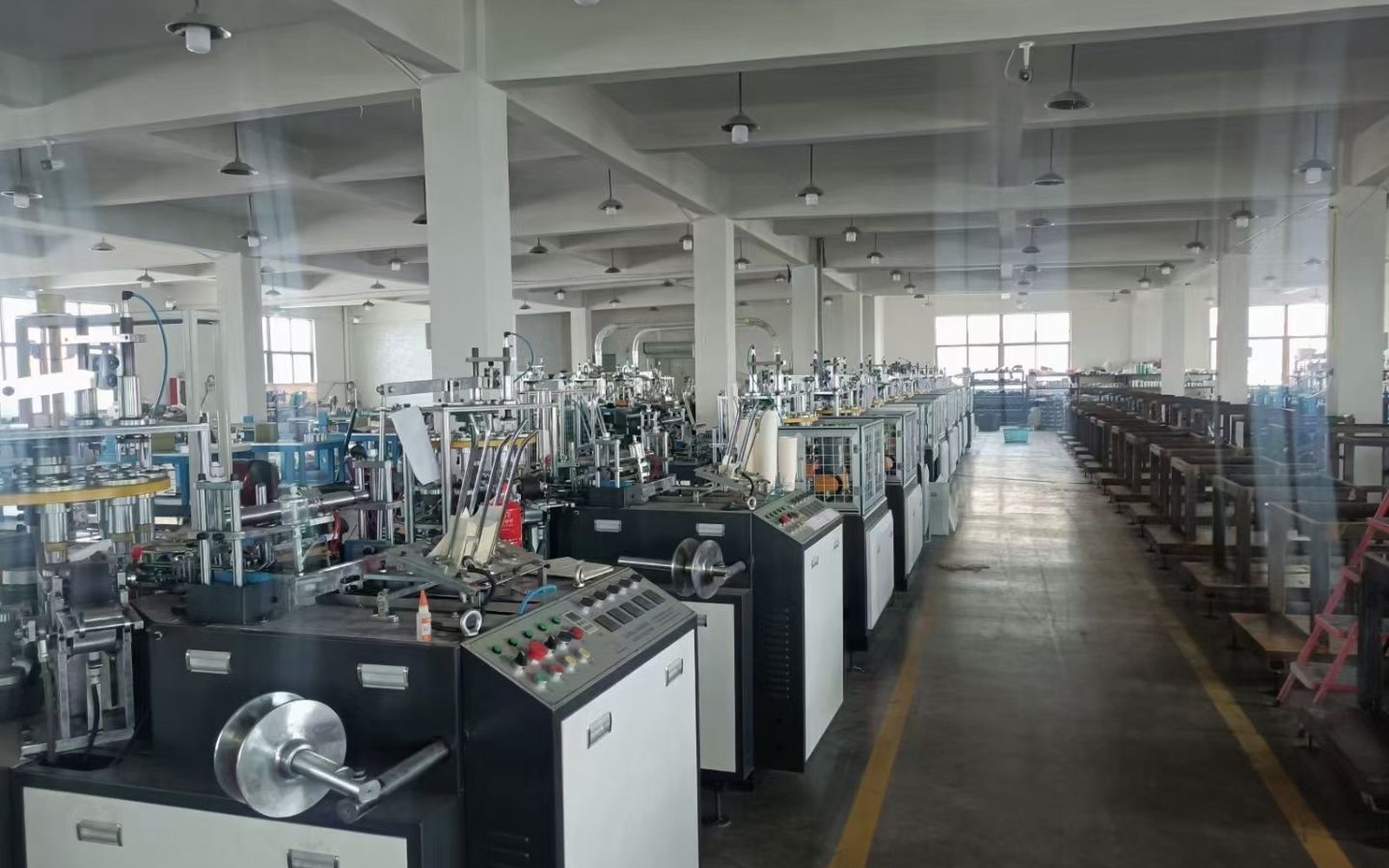 Paper cup machines arranged in an industrial workshop for factory layout planning