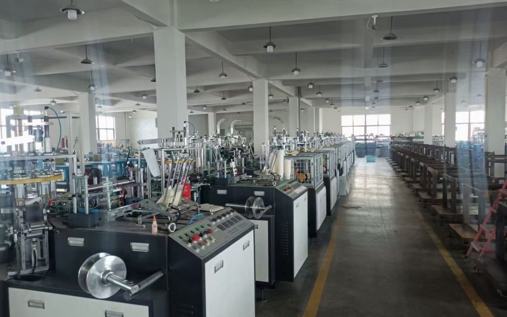 Paper cup machines arranged in a manufacturing workshop for supplier evaluation